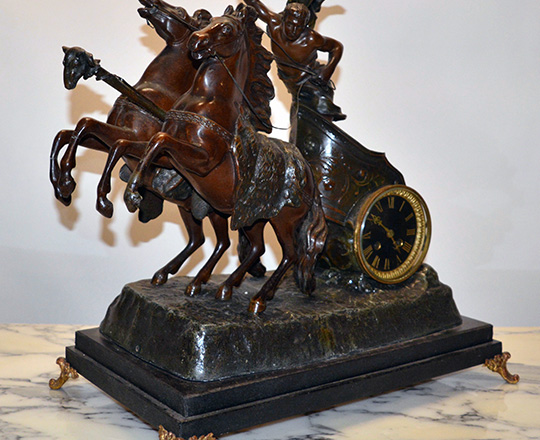 Lot 114_1: Fairly large bronze wash spelter mantle clock; young gladiator racing with horses on a chariot. H53xW53xD30cm.