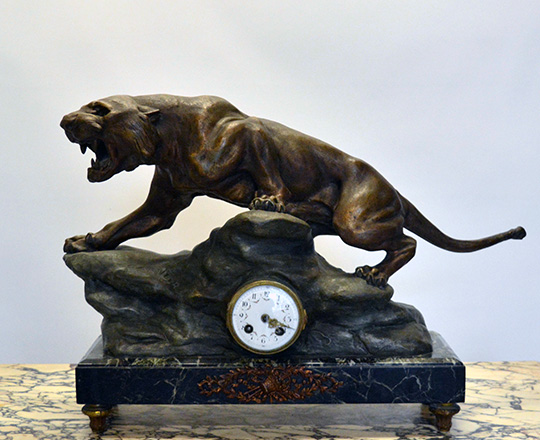 Lot 128: Early cent bronze wash spelter mantel clock; lioness signed 'Cartier'. H43xW63cm.