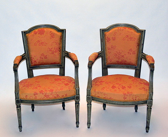Lot 144: Pr 19th cent painted Louis XVI chairs covered by salmon color floral pattern tissue.