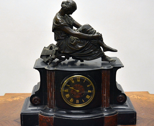 Lot 155: 19th c Nap.lll black/red marble mantel clockwith bronze statue of woman resting by arp. M