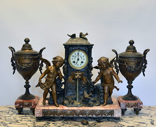 Lot 159: 19th c bronze wash spelter clock garniture of two puttis by fountain (of youth?) H41cm and lidded vases H39cm
