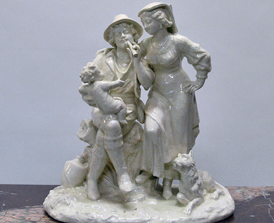 Lot 191: Turn cent, white varnished ceramic statue of couple with child. H 36cm.