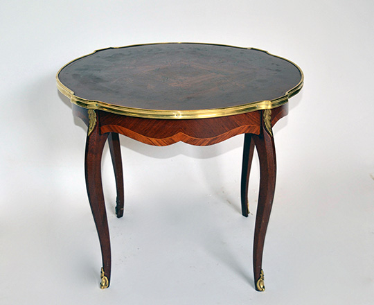 Lot 281:  Round Louis XV low center table with floral marquetry top and brass skirt. H50 x dia.61cm.