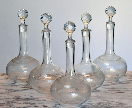 Lot 336: Set of five crystal ingraved liquor decanters. H 27cm.