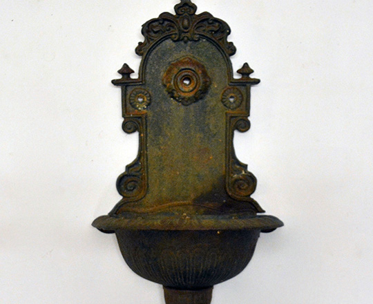 Lot 342: Green painted cast iron wall fountain. H57cm.