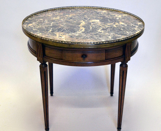 Lot 351: Louis XVI style low ''Bouillotte'' marble top center table with two drawers & side tablets. H57,5 x dia.65cm.
