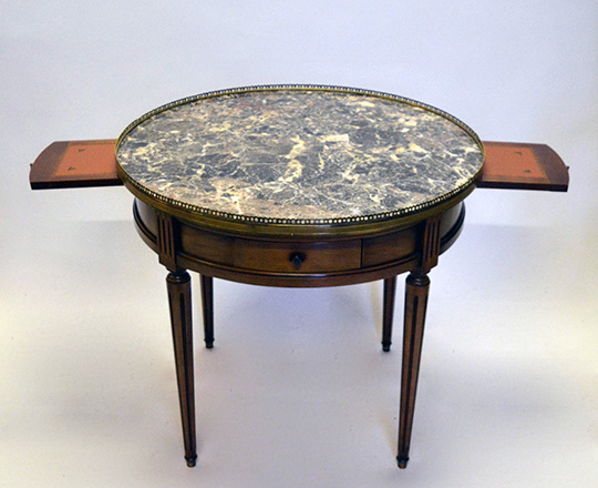 Lot 351_1: Louis XVI style low ''Bouillotte'' marble top center table with two drawers & side tablets. H57,5 x dia.65cm.