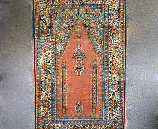 Lot 354: small hand woven carpet.110 x 66cm.