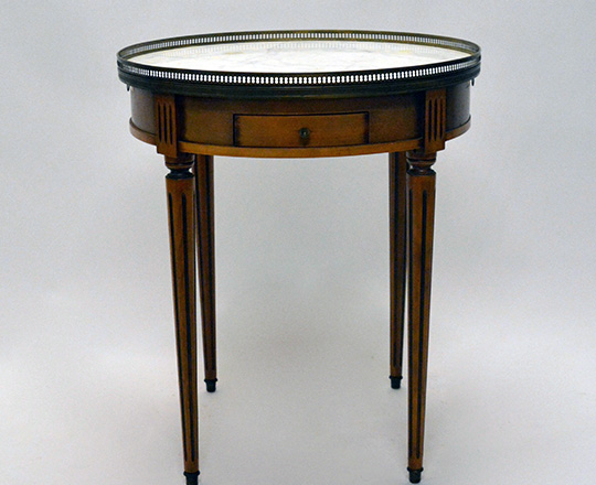 Lot 370: Louis XVI style marble top ''bouillotte'' table with two drawers nad tablets. H70 x dia. 60cm.