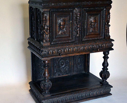 Lot 405_1: 17th cent well restored two stage oak cabinet on a console base with finely carved faces on top section. H139xW101xD57cm.
