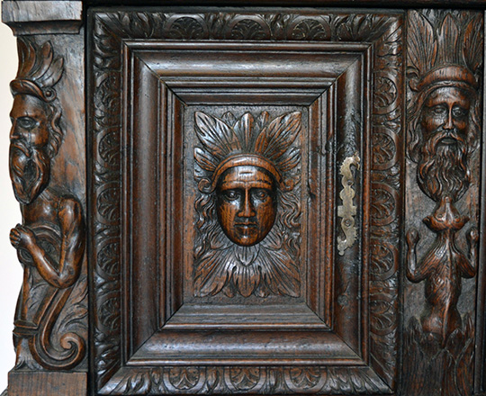 Lot 405_3: 17th cent well restored two stage oak cabinet on a console base with finely carved faces on top section. H139xW101xD57cm.