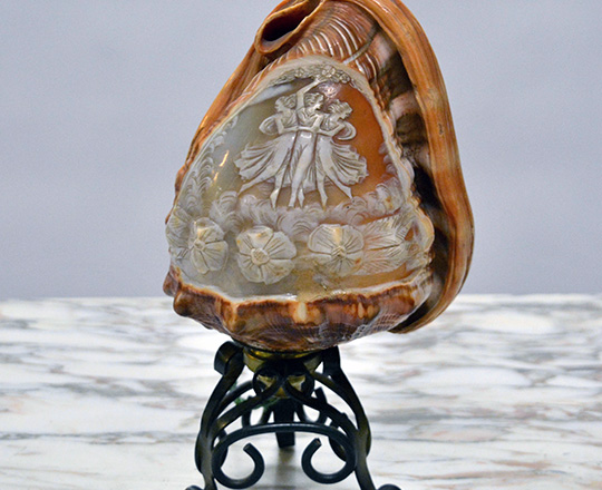 Lot 482: Turn cent. Finely sculpted ''Night light'' shell with the three 'Graces'. (elec.). H20cm.