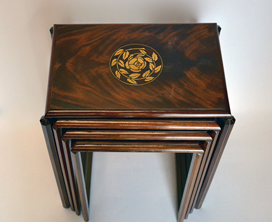 Lot 504_1: Elegant Art Deco flamed mahogany nest of (4) tables with floral marquetry crown inlay. (Dominique?) H70xW59xD40cm.