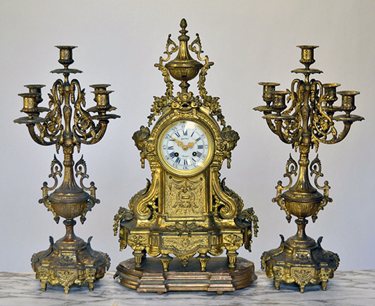 Lot 581: Large gilt bronze Louis XVI mantle clock garniture, H54xW32cm + large pair of 5 light candelabras,H52cm.