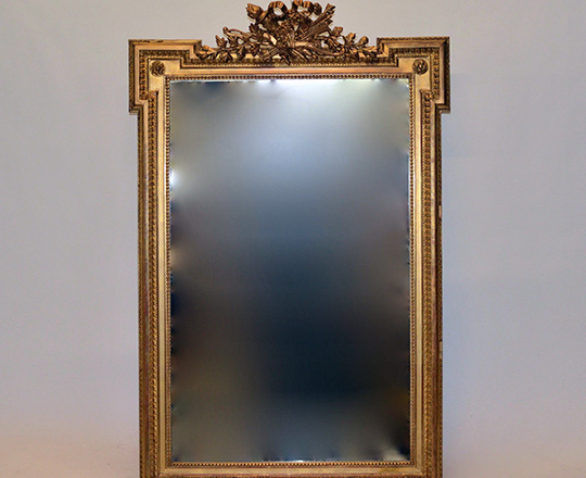 Lot 595: 19th cent Louis XVI gold leaf bevelled mirror with finely ornated pediment.(small acc.& scratches) H146xW95cm.