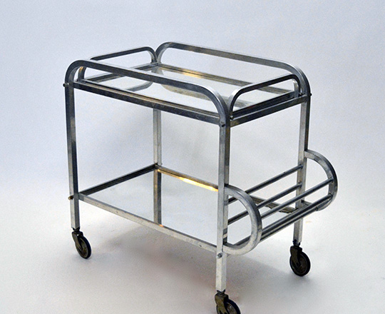 Lot 596: Art Deco aluminium bar cart on wheels with removable tray. (acc. on bottom mirror) H76xW72xD40cm.