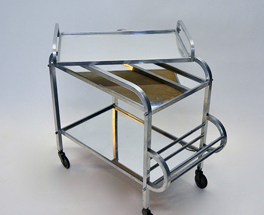 Lot 596_2: Art Deco aluminium bar cart on wheels with removable tray. (acc. on bottom mirror) H76xW72xD40cm.