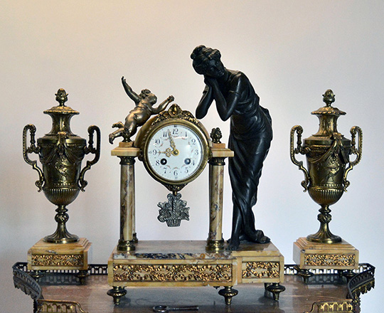 Lot 71: 19th cent Louis XVI portico clock,H42cm. garniture with bronze patinated spelter statue of lady & pr. gilt lidded vases,H37cm.